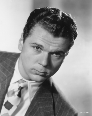 circa 1942: Promotional headshot portrait of American actor Jackie Cooper tilting his head forward and looking straight ahead, for director A Edward Sutherland's film, 'The Navy Comes Through'. He is wearing a pinstriped blazer with a tie. (Photo by Hulton Archive/Getty Images)